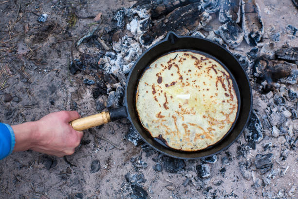 istock Cooking pancakes on the fire in the forest. 1003909950