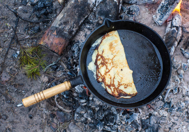 istock Cooking pancakes on the fire in the forest. 1003912318