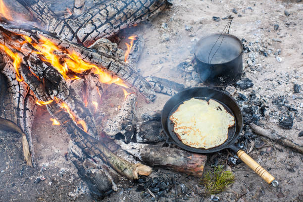 istock Cooking pancakes on the fire in the forest. 1003912468