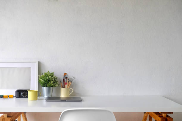 istock Stylish workspace with poster and gadget.