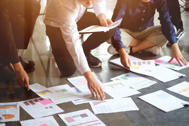 istock Group of business working together on a creative project. 1003912938