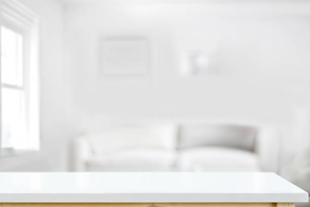 istock White top table for display montage over bright living room background. 1003912998