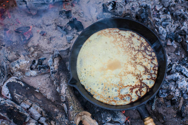 istock Cooking pancakes on the fire in the forest. 1003917986