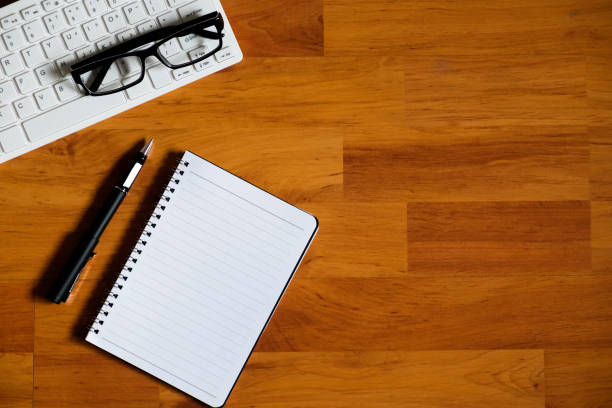 istock Wood office desk table with laptop, notebook and supplies. 1003923288