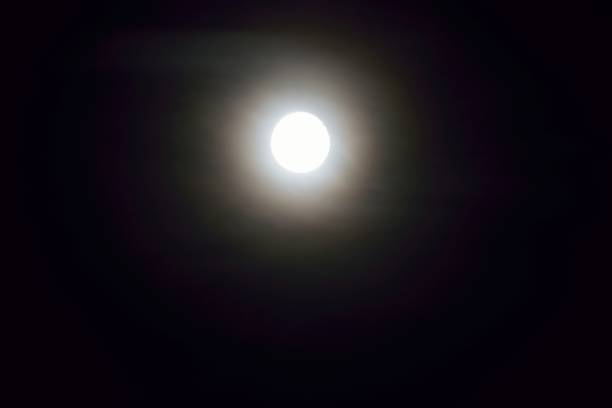 istock Background of shining full moon in dark night sky 1003923578