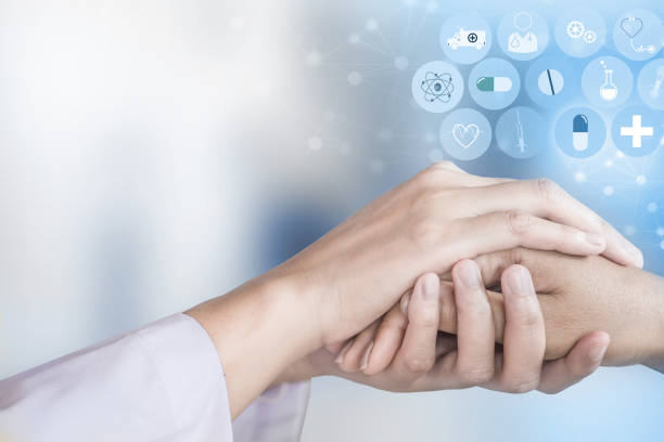 istock doctor holding patient hand with modern medical technology background 1003951848