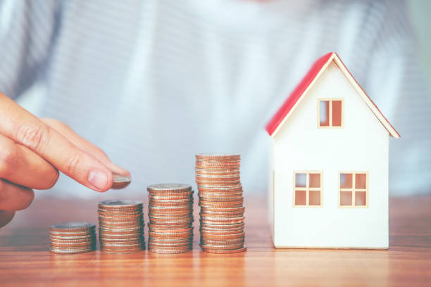 istock Saving money concept man hand putting coin stack finance for budget 1003964722