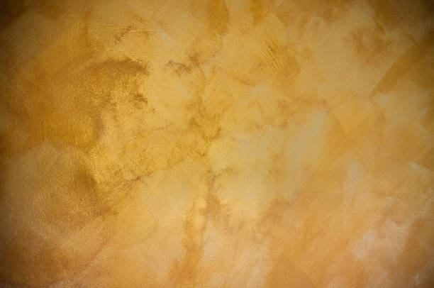 istock Abstract gold background with grunge aged concrete texture 1003973712