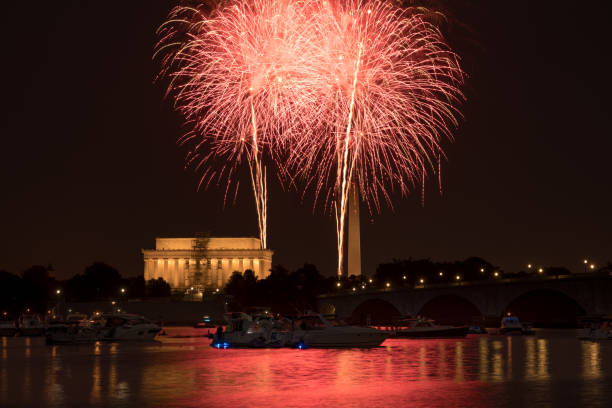 Fireworks over the Washington Monument and Lincoln Memorial on July 4, 2018. Reflection of fireworks visible in the Potomac. Washington DC July 4, 2018: Fireworks over the Washington Monument and Lincoln Memorial on July 4, 2018. Reflection of fireworks visible in the Potomac. arlington memorial bridge photos stock pictures, royalty-free photos & images