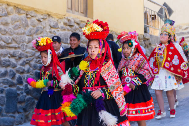 Ollantaytambo, Peru - May 16 : Religious celebration for Fiestas de Pentecostes with people wearing masks and colorful clothing on the streets of Ollantaytambo. May 16 2016, Ollantaytambo Peru.
