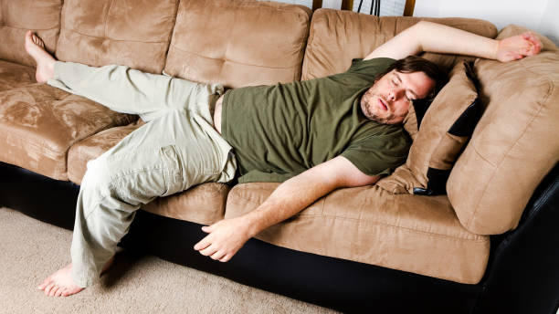 istock A guy flung all over the couch 1003976520