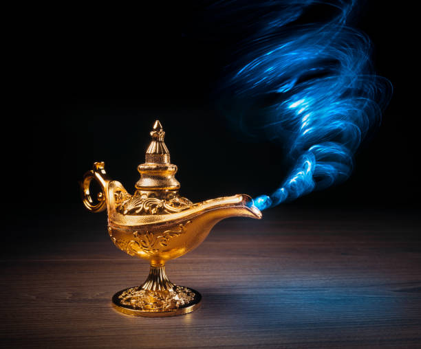 istock Magic Lamp with smoke in a dark background 1003979420
