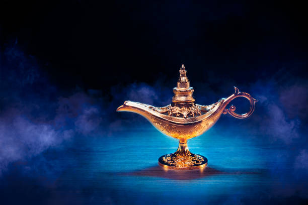 istock Magic Lamp with smoke in a dark background 1003979586