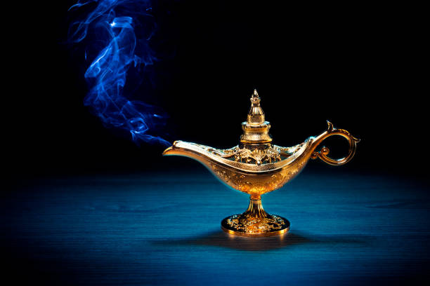 istock Magic Lamp with smoke in a dark background 1003982522