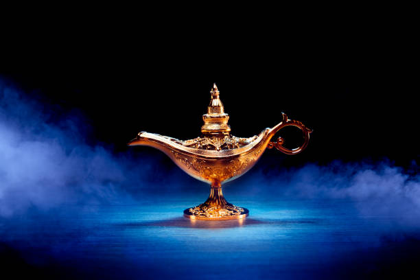 istock Magic Lamp with smoke in a dark background 1003982748