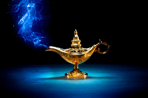 Magic genie lamp with smoke on a dark background