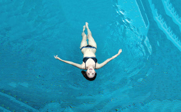 istock happy asian lady smiling to camera with bikini 1003985750