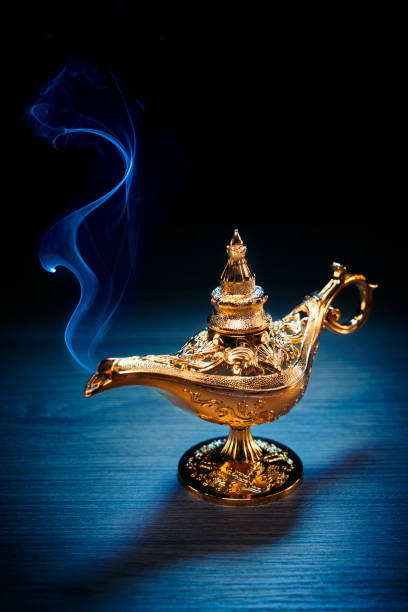 istock Magic Lamp with smoke in a dark background 1003985988