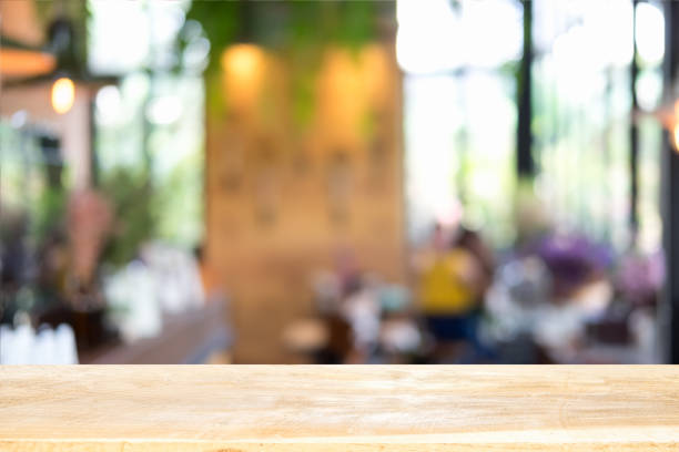 istock Empty wooden table and blurred cafe background, can be used for display or montage your products 1003988984