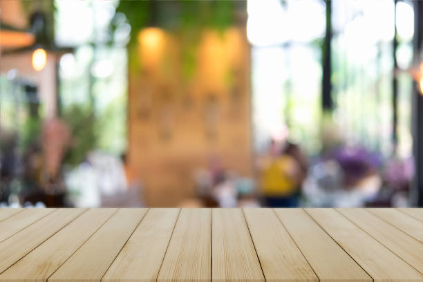 istock Empty wooden table and blurred cafe background, can be used for display or montage your products 1003988990