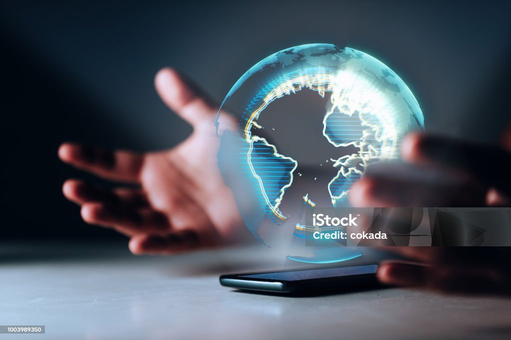 Holographic Earth on smartphone Technology Stock Photo