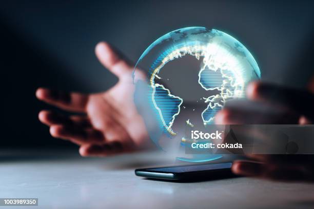 Holographic Earth On Smartphone Stock Photo - Download Image Now - Technology, World Map, Global Business