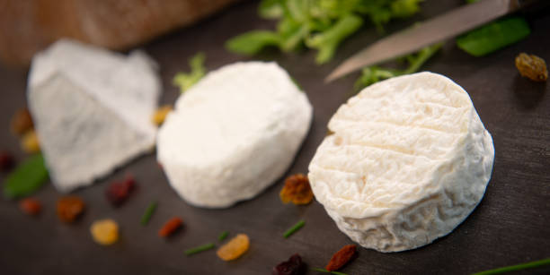istock French goats cheeses and bread on background 1003989476