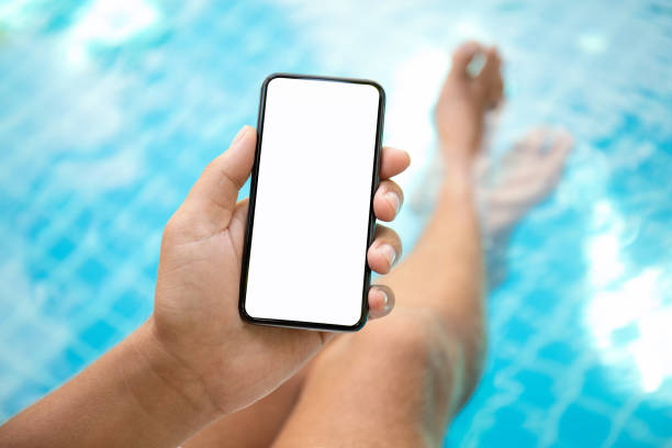 istock man at the pool holding phone with an isolated screen 1003989506