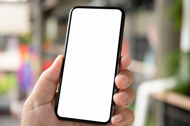 istock man hand holding phone with isolated screen on background city 1003989614