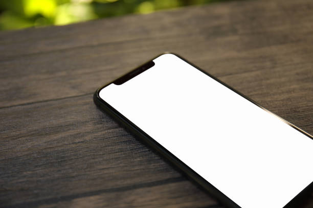 istock phone with an isolated screen on a table in cafe 1003989654
