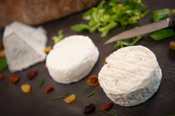 istock French goats cheeses and bread on background 1003989672