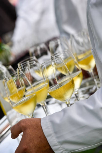 istock Professional waiter in uniform is serving wine 1003990116
