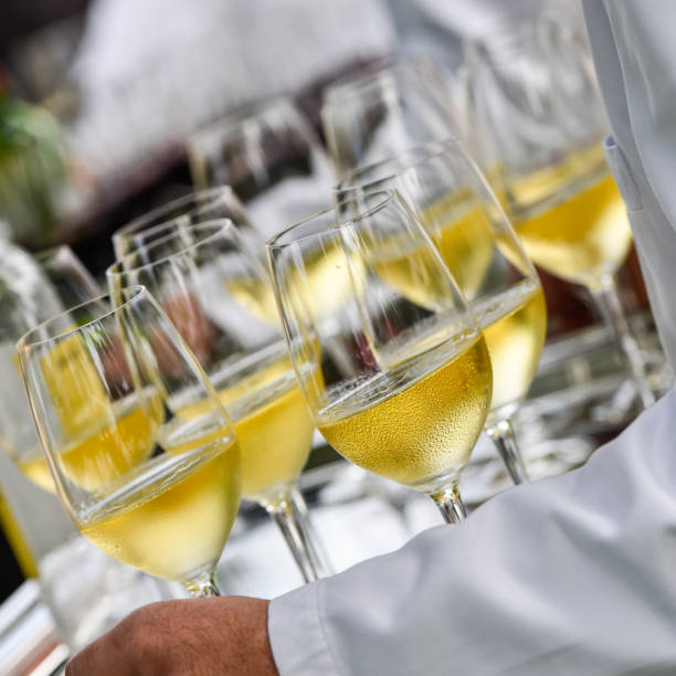 istock Professional waiter in uniform is serving wine 1003990332