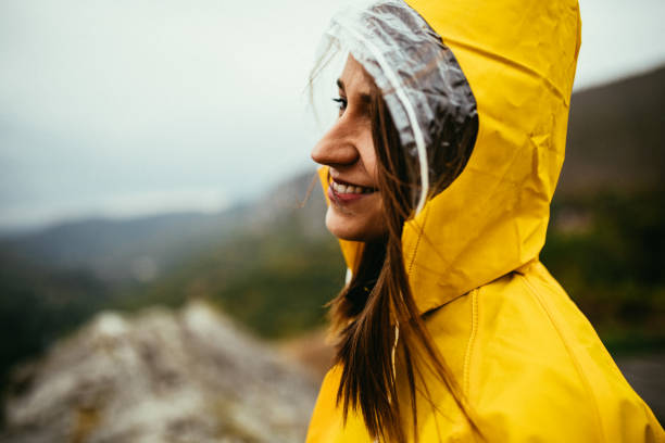 istock Cute woman in yellow raincoat 1003991478