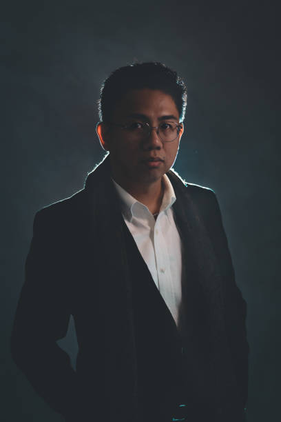 istock one asian chinese mid adult man looking at camera standing in a studio 1003993900