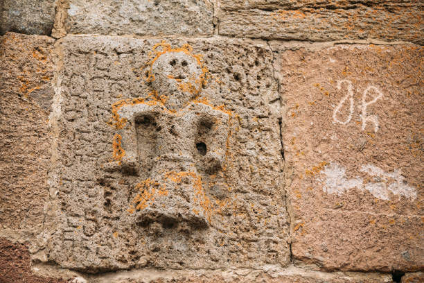 istock Architectural Details Of Bas-reliefs On Wall Of Gergeti Trinity Church. Tsminda Sameba - Holy Trinity Church Near Village Of Gergeti Near Kazbegi In Georgia 1003994054