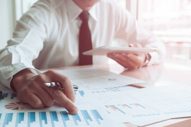 istock Asian business people meeting with new startup project pointing graph discussion and analysis data charts and graphs.Business finances and accounting concept 1003995202
