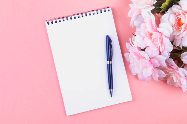 istock Empty notebook with blue pen on a pink pastel background. mock-up, frame, template. 1003997754