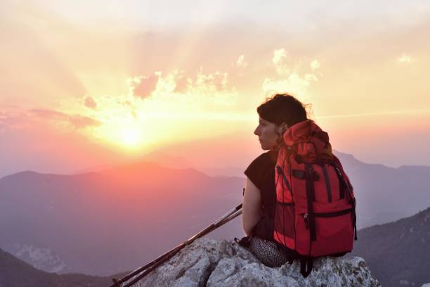 istock female hiker resting and watching the sunset 1003998186