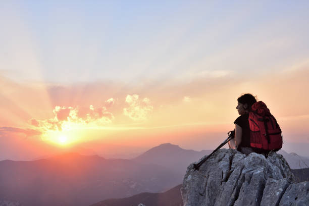 istock female hiker resting and watching the sunset 1004001640