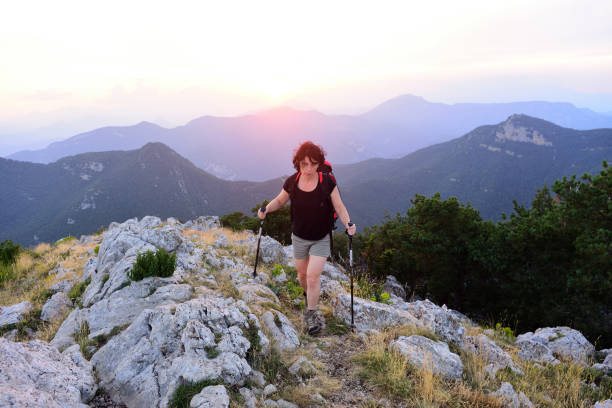 istock Hiker woman walking at sunset 1004007254