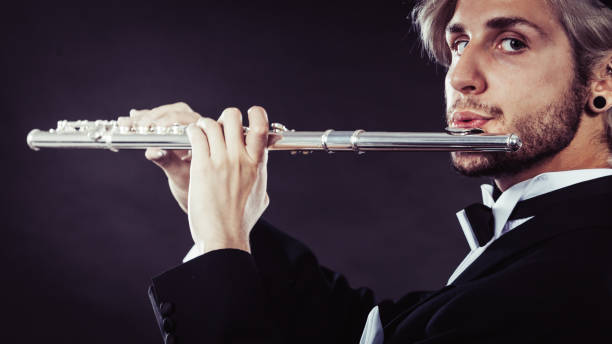 Turkish musician playing the reed flute  with black background and fogs