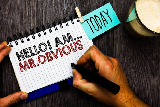 Word writing text Hello I Am.. Mr.Obvious. Business concept for introducing yourself as pouplar or famous person Man holding marker notebook clothespin hold reminder coffee cup wood table.