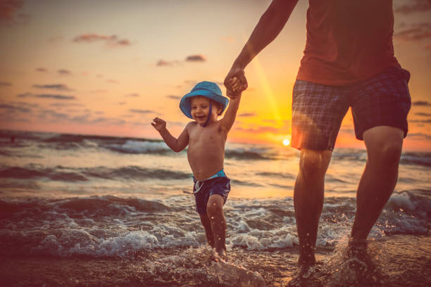 Family having fun on the beach in the evening