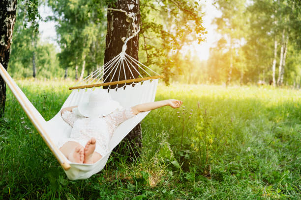 istock Woman resting in hammock. Sleeping outdoors. 1004016166