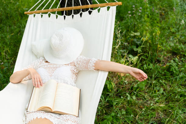 istock Woman resting in hammock. Sleeping outdoors. 1004016240