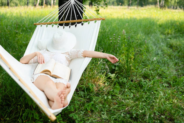 istock Woman resting in hammock. Sleeping outdoors. 1004016334