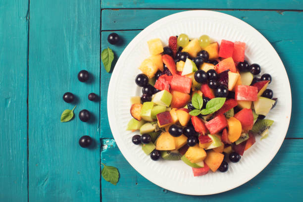 istock Mixed summer fruits salad top view 1004016350