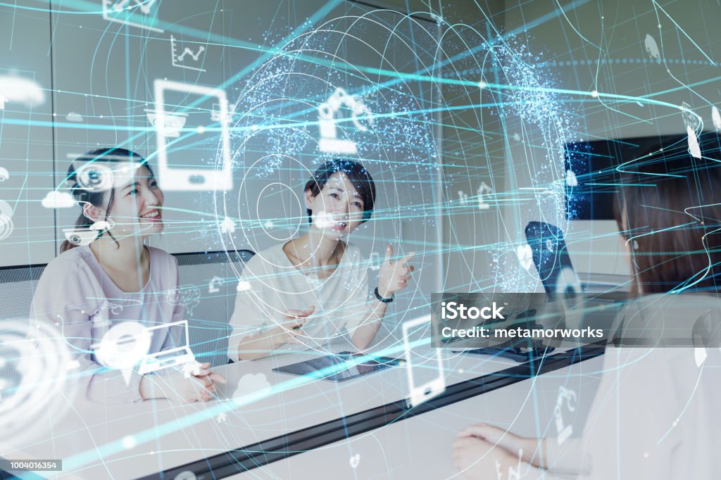 IoT (Internet of Things) concept. Group of asian businesswoman working in the office. Japanese Ethnicity Stock Photo