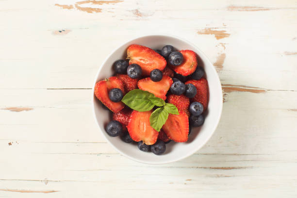 istock Mixed summer fruits salad top view 1004016840
